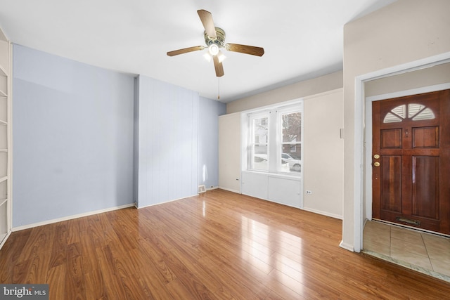 entryway with ceiling fan and wood-type flooring