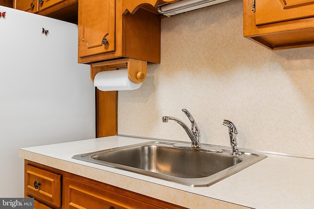 kitchen featuring sink and white fridge