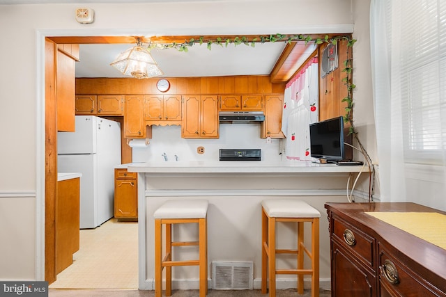 kitchen with white fridge and stove