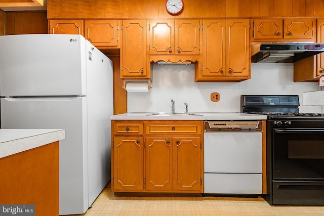 kitchen featuring sink and white appliances