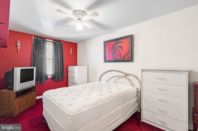 bedroom with ceiling fan and dark carpet