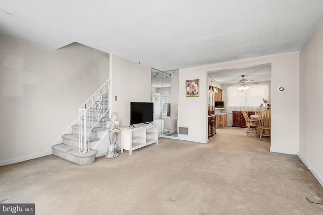 living room with ceiling fan, carpet floors, and a wealth of natural light