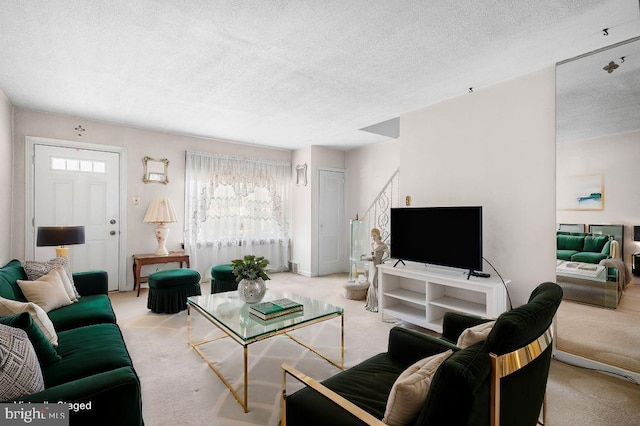 living room with light colored carpet and a textured ceiling