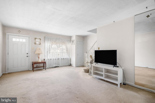 carpeted living room with a textured ceiling