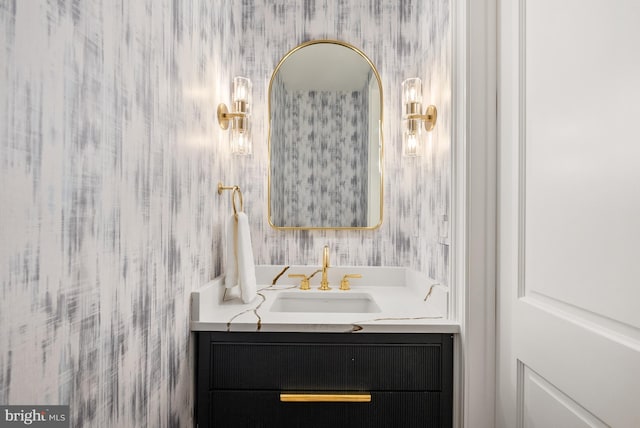 bathroom featuring vanity and wallpapered walls