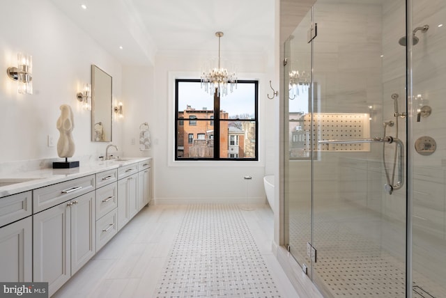 bathroom featuring double vanity, a stall shower, and a sink