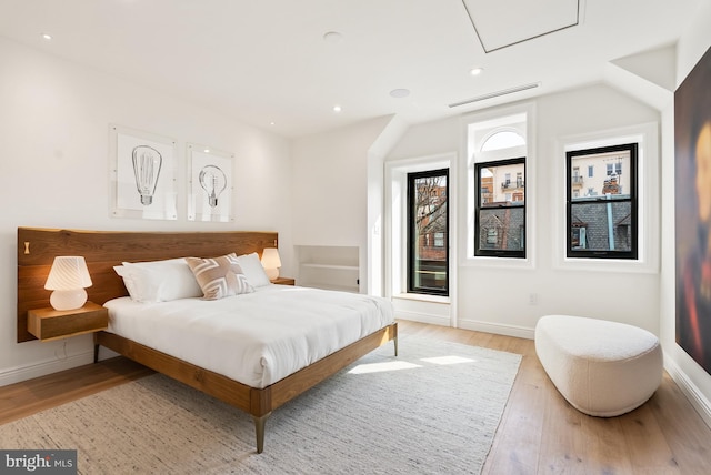 bedroom with light wood-type flooring, baseboards, visible vents, and recessed lighting