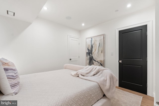 bedroom featuring recessed lighting, visible vents, and light wood finished floors