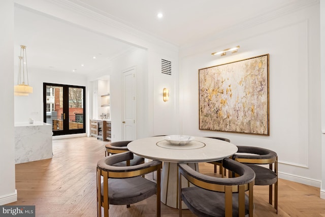 dining space with french doors, crown molding, recessed lighting, visible vents, and baseboards