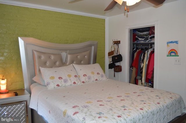 bedroom with ceiling fan, brick wall, and a closet