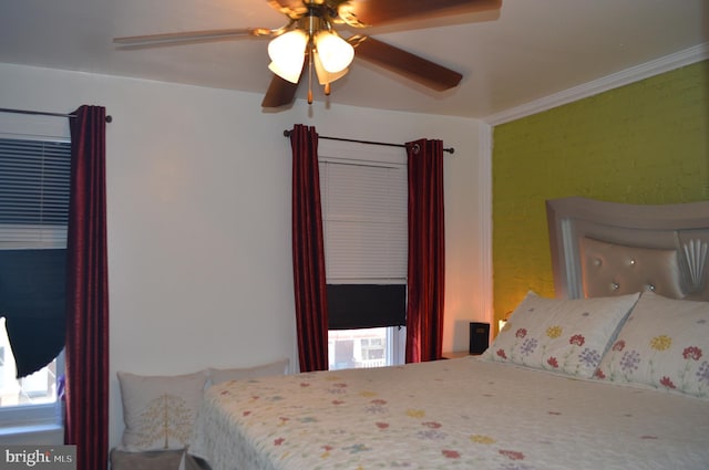 bedroom with ornamental molding and ceiling fan