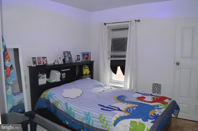 bedroom featuring parquet flooring