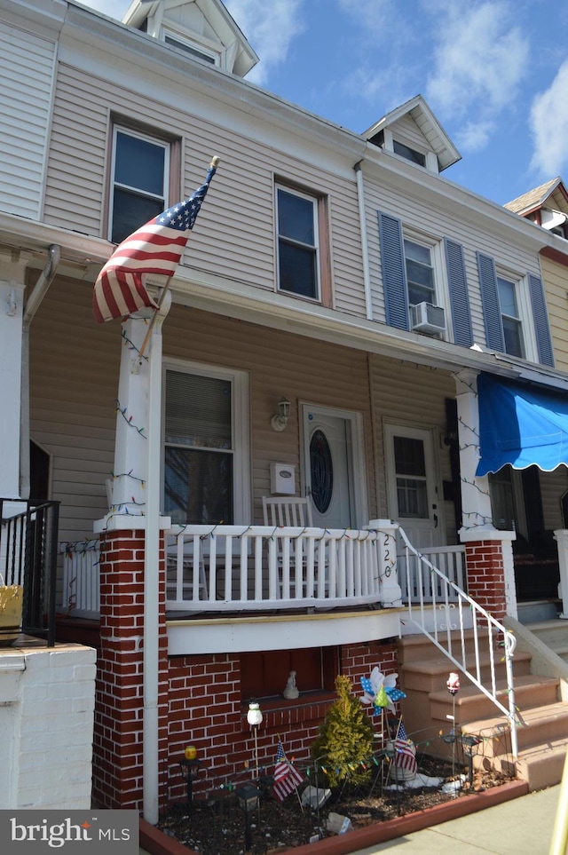 multi unit property featuring cooling unit and covered porch