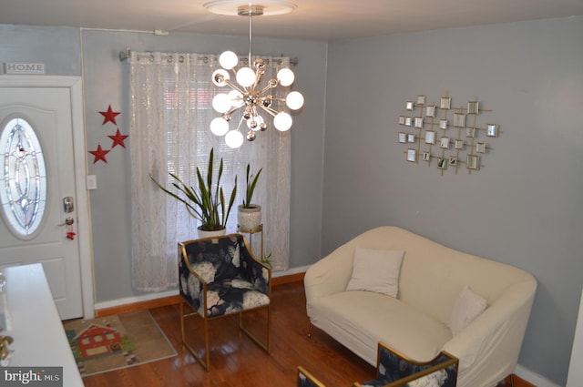 living area with hardwood / wood-style floors and an inviting chandelier