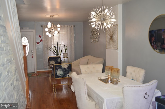 dining room featuring an inviting chandelier and dark wood-type flooring