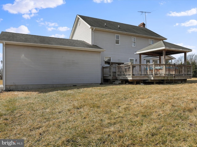 back of property featuring a gazebo, a yard, a chimney, and a wooden deck