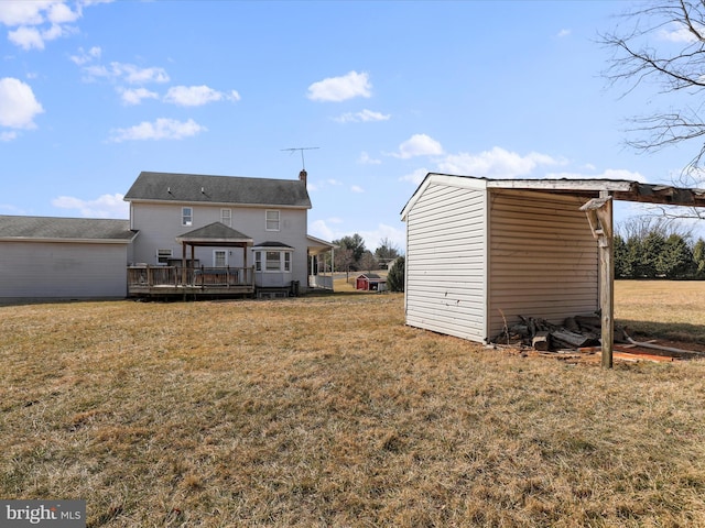 exterior space with an outbuilding, a yard, a deck, and a gazebo