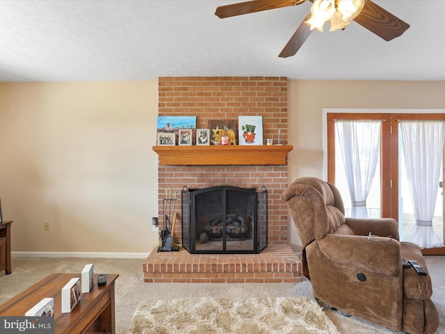 carpeted living room featuring a brick fireplace, a textured ceiling, and baseboards