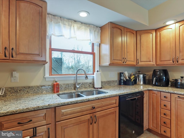 kitchen featuring light stone counters, recessed lighting, dishwasher, and a sink