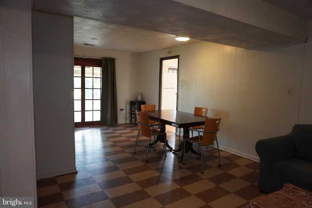 dining space featuring tile patterned floors and baseboards