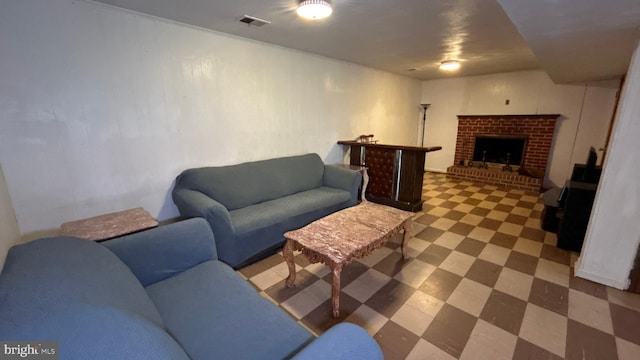 living area featuring a fireplace, visible vents, and tile patterned floors