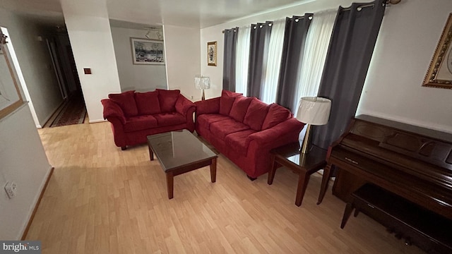 living area featuring light wood finished floors and baseboards
