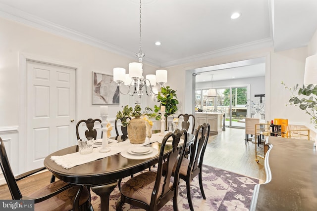 dining area with ornamental molding, a chandelier, wood finished floors, and recessed lighting