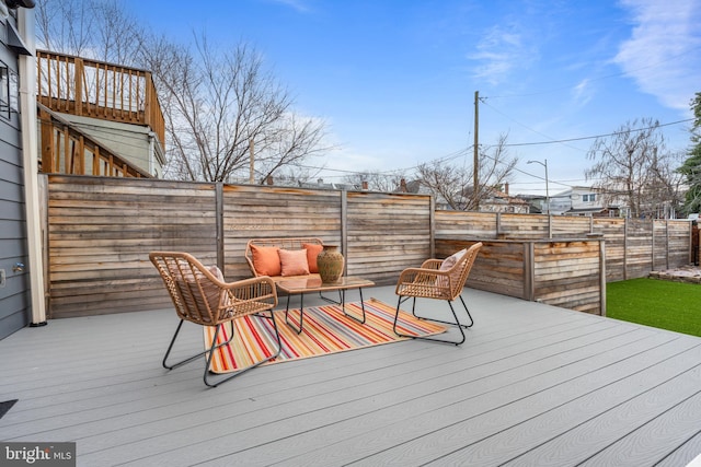 wooden terrace with a fenced backyard and stairway