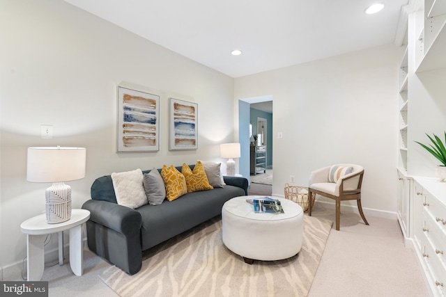 living room with baseboards, light colored carpet, and recessed lighting