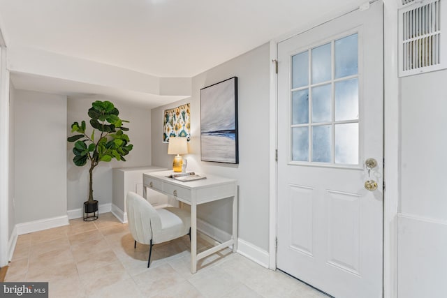 entryway with light tile patterned floors and baseboards