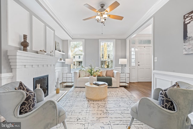 sunroom with a ceiling fan and a fireplace