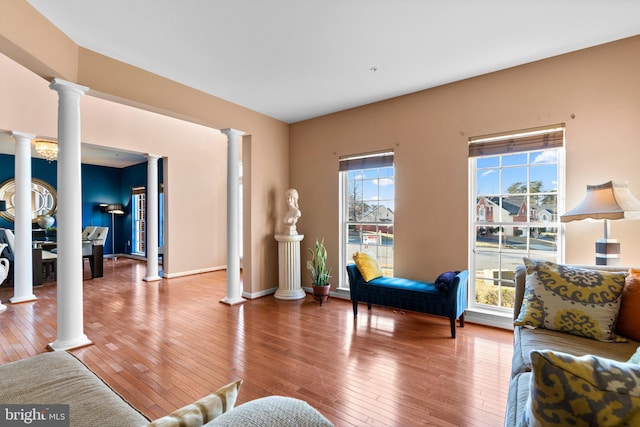 living room with hardwood / wood-style floors and decorative columns