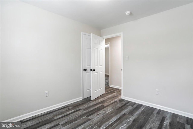 spare room featuring dark hardwood / wood-style floors