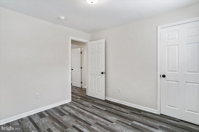 spare room featuring dark wood-type flooring