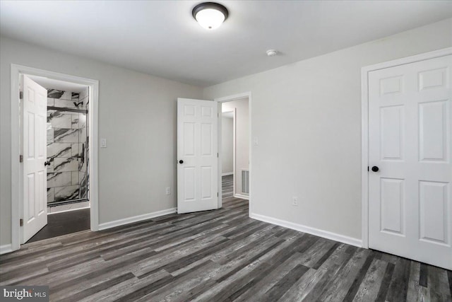 unfurnished bedroom with dark hardwood / wood-style floors