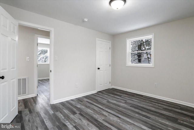 empty room featuring dark hardwood / wood-style flooring