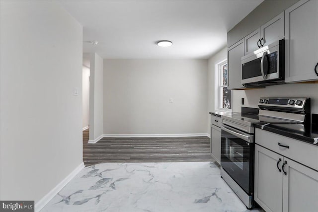 kitchen with stainless steel appliances and gray cabinetry