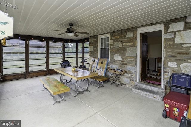 sunroom / solarium featuring ceiling fan