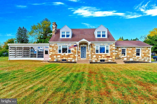 cape cod house with a front yard