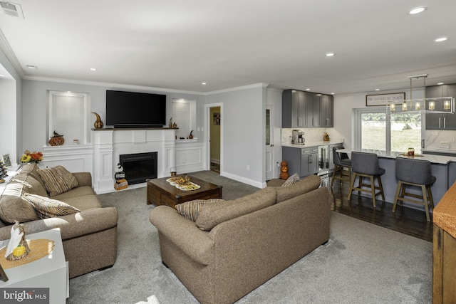 living room featuring ornamental molding and light wood-type flooring