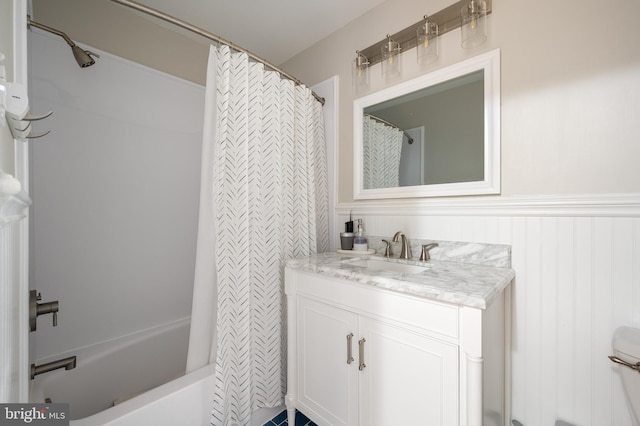 full bath with wainscoting, vanity, a shower with shower curtain, and a bathing tub