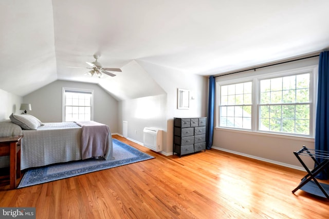 bedroom featuring vaulted ceiling, light wood-style flooring, baseboards, and ceiling fan