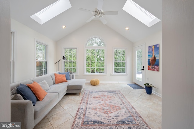 living room featuring light tile patterned floors, a skylight, baseboards, high vaulted ceiling, and recessed lighting