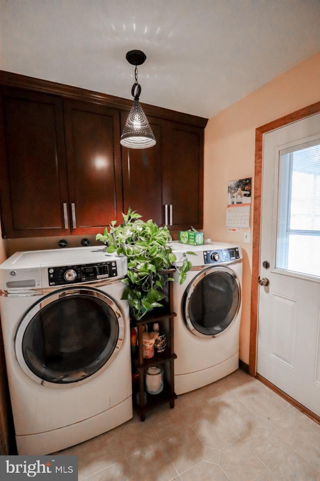 washroom featuring cabinets, independent washer and dryer, and light tile patterned flooring