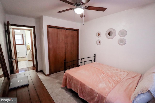 carpeted bedroom featuring ceiling fan and a closet