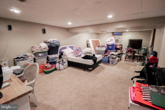 rec room with carpet and a paneled ceiling