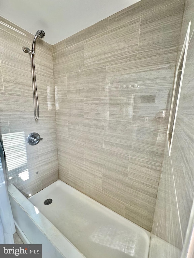 bathroom with a tile shower