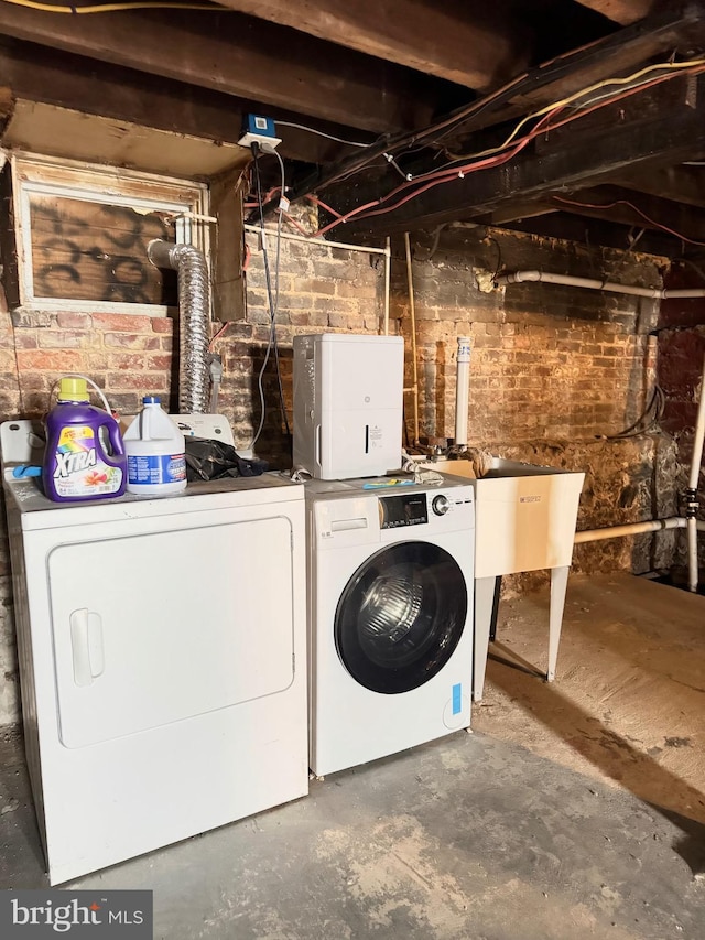 laundry room featuring washing machine and clothes dryer