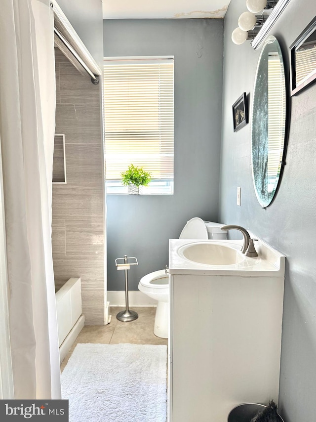 full bathroom featuring shower / bath combination with curtain, vanity, tile patterned floors, and toilet