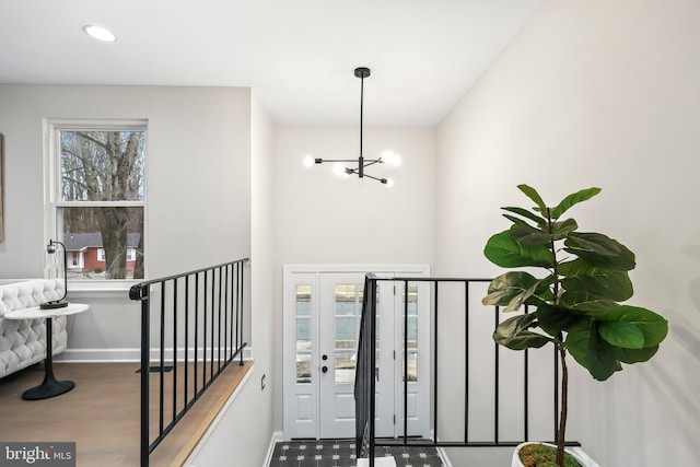 interior space with recessed lighting, baseboards, a notable chandelier, and wood finished floors